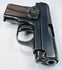 FN Browning Model 1906 highlighting the barrel opening, rounded steel contours, and wear along the textured grip.