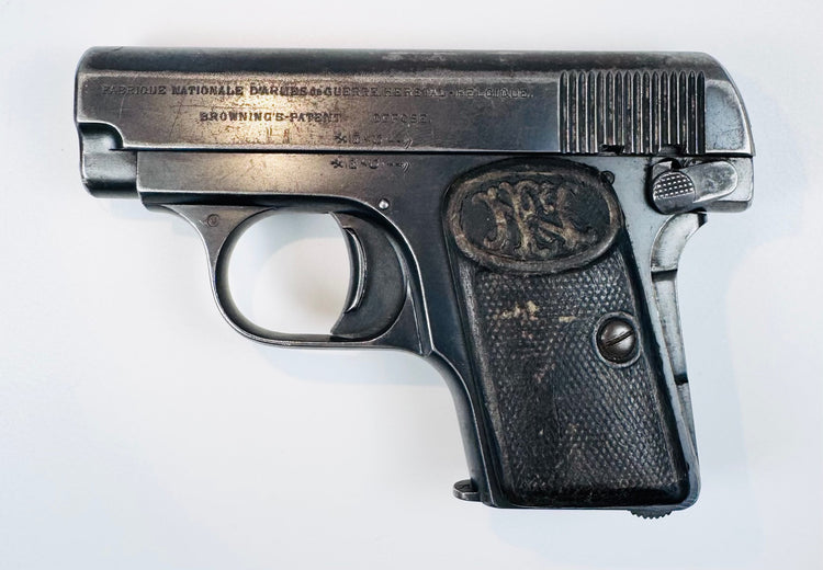 Belgian FN Browning Model 1906 with stamped slide lettering, a curved trigger, and a textured FN-monogram grip.