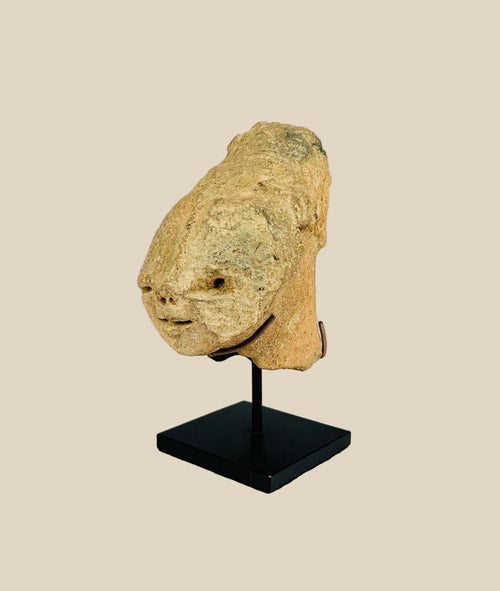 Ancient Bura culture terracotta head from Niger, West Africa, circa 300–1100 CE. Stylized lips, flat nose, and subtle rear ornamentation with natural patina. Likely created for ceremonial or funerary purposes, reflecting the symbolic, abstract artistry and spiritual traditions of early West African societies.