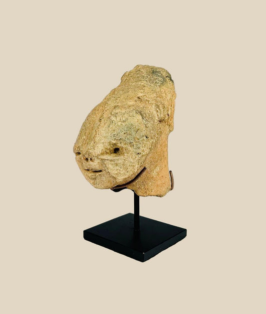Ancient Bura culture terracotta head from Niger, West Africa, circa 300–1100 CE. Stylized lips, flat nose, and subtle rear ornamentation with natural patina. Likely created for ceremonial or funerary purposes, reflecting the symbolic, abstract artistry and spiritual traditions of early West African societies.