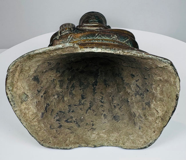 Open underside of the hollow-cast Burmese bronze Buddha with mineral deposits