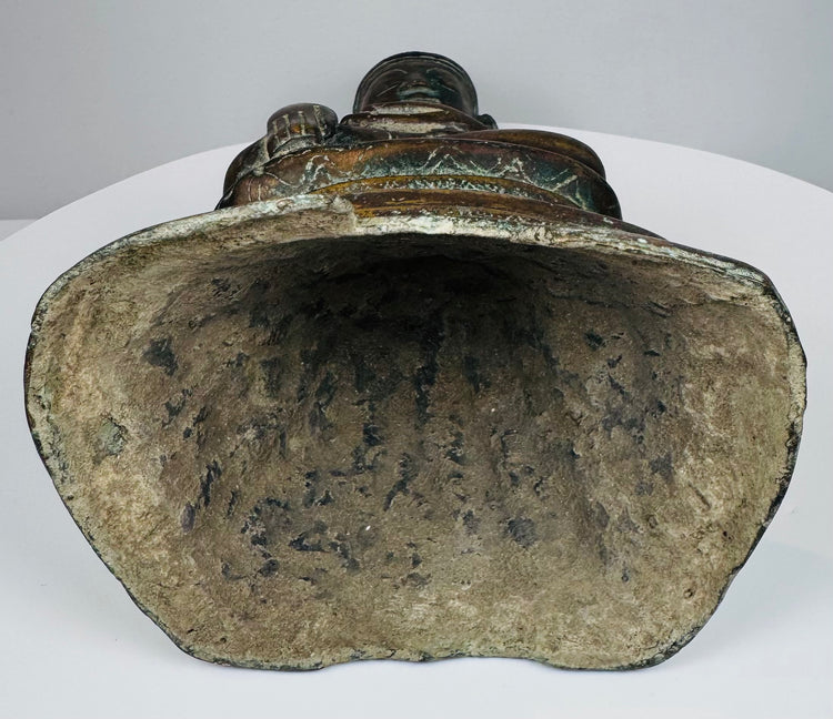 Open underside of the hollow-cast Burmese bronze Buddha with mineral deposits