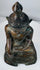 Close view of the Buddha’s curled hair, broad ushnisha, and lotus-bud finial