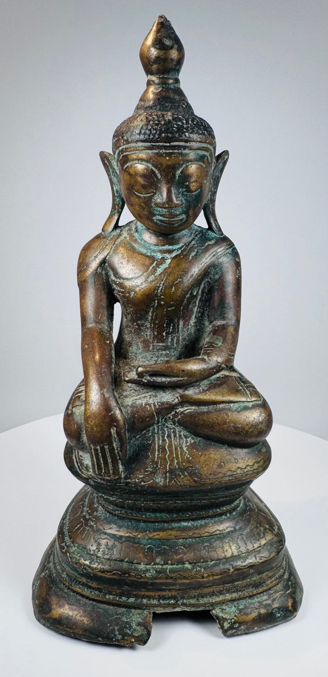 Full front view of the antique Myanmar bronze Buddha in bhumisparsha mudra