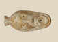 Ancient Byzantine terracotta oil lamp featuring a molded human face with open mouth spout, dating from the 5th to 7th century AD, showing aged surface encrustations.