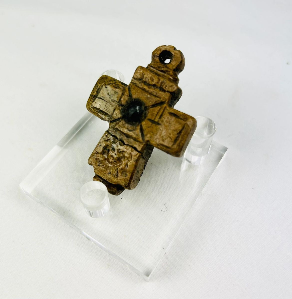 Ancient Byzantine carved bone cross pendant, incised with cross motif and central raised boss, worn devotional artifact, circa 900–1200 AD.