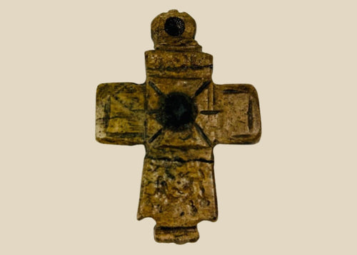 Ancient Byzantine carved bone cross pendant, incised with cross motif and central raised boss, worn devotional artifact, circa 900–1200 AD.