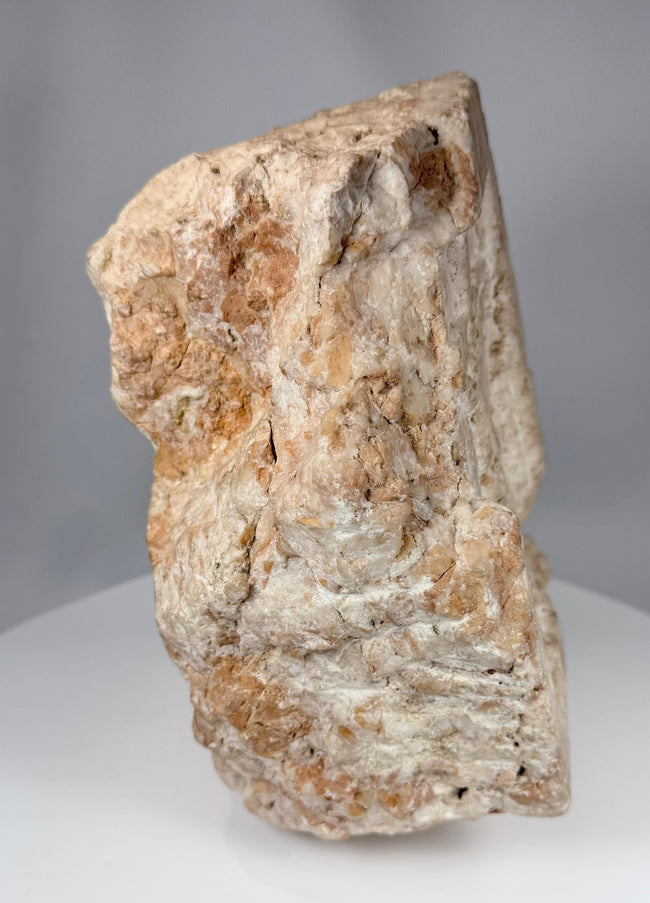 Fragmentary ecclesiastical stone sculpture showing a crucifixion scene in high relief carving