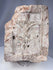 Antique European ecclesiastical stone relief showing a crucifixion scene with carved buildings and tree motif