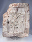 Antique European ecclesiastical stone relief showing a crucifixion scene with carved buildings and tree motif