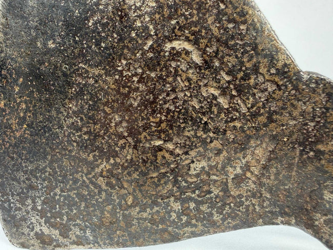 Historic colonial iron axe head measuring approximately 8.5 by 7 inches with aged patina