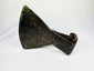 Close-up of 18th-century iron axe head surface texture and maker’s punch mark.
