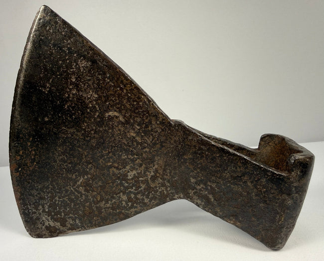 18th-century cast iron axe head with faint punched maker’s mark and extensive age-related oxidation