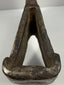 Heavy 18th-century cast iron axe head with oxidized patina and indistinct punched motif