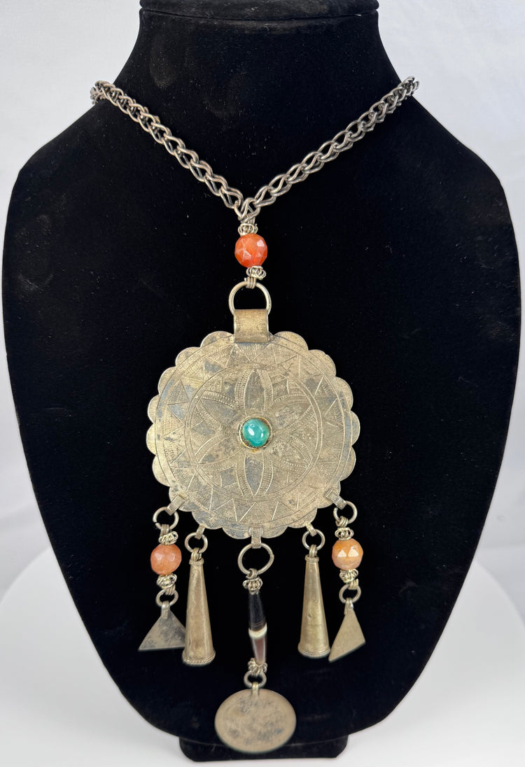Tribal necklace with turquoise-coloured centre, orange beads, and geometric decoration