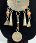 Traditional Afghan jewellery with rosette motif, coloured beads, and aged metal patina