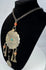 Kuchi-style ceremonial necklace with banded bead and Arabic or Persian-script coin
