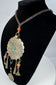 Kuchi-style ceremonial necklace with banded bead and Arabic or Persian-script coin