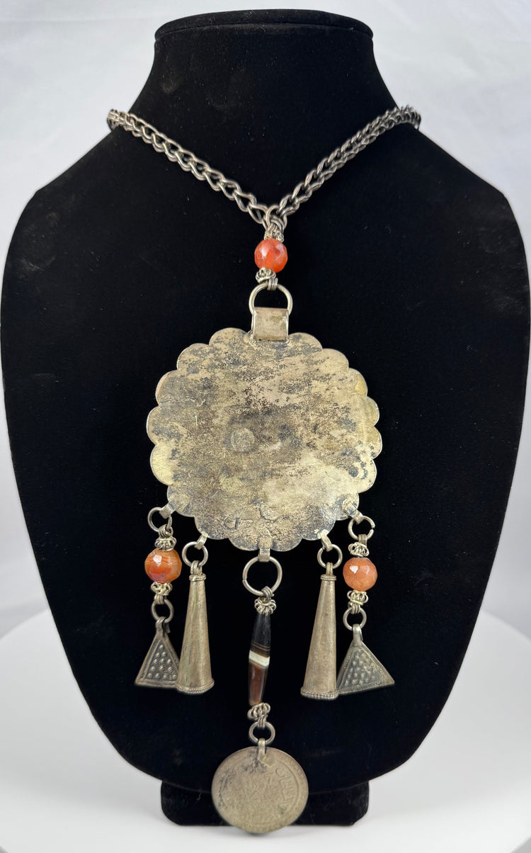 Central Asian tribal jewellery with engraved rosette pendant and suspended metal ornaments