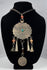 Large scalloped tribal pendant with punched borders and hand-fashioned suspension rings