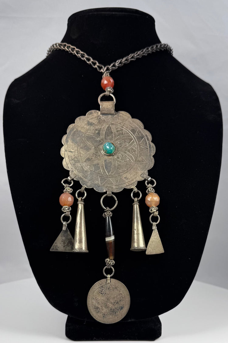 Large scalloped tribal pendant with punched borders and hand-fashioned suspension rings
