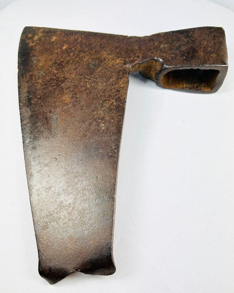 Reverse angle of rustic iron axe head showing hollow rectangular eye socket and curved blade