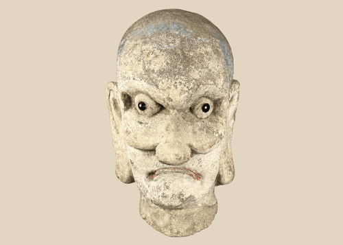 Qing Dynasty carved Chinese stone head of a Luohan with traces of original polychrome pigment.