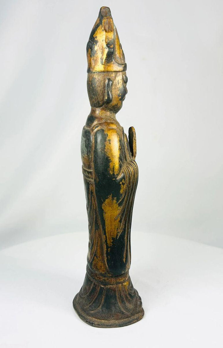 Side profile of a Qing Dynasty Tibetan Lama bronze sculpture with flared base