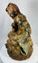Antique Chinese temple sculpture of Jigong with naturalistic vine leaves and gourds.