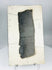 Chinese inscribed ceramic fragment displayed on stand highlighting texture, patina, and incised characters