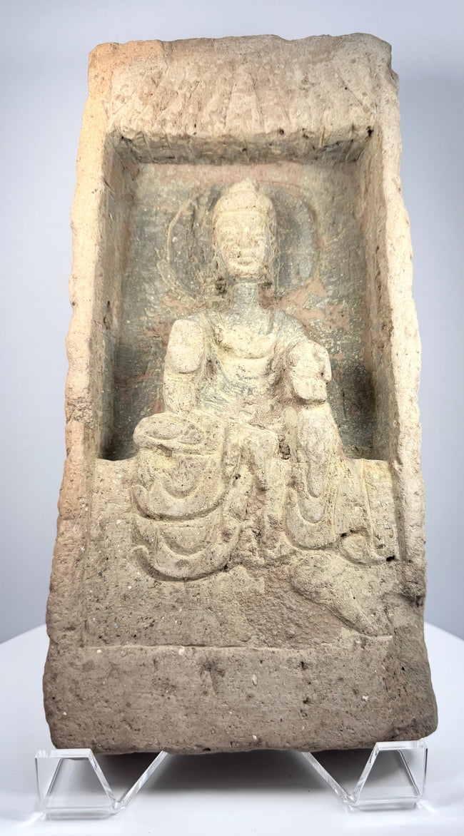 Northern Wei terracotta Buddha relief with circular halo, flowing robes and traces of ancient pigment