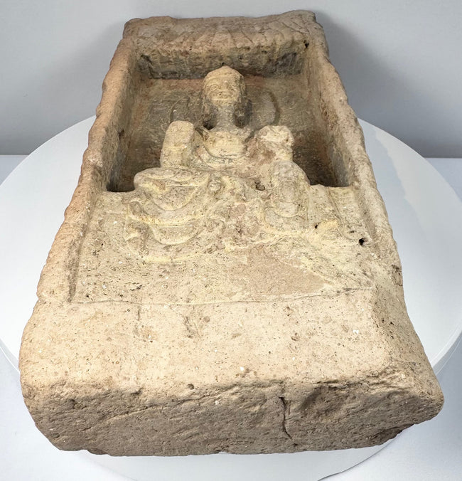 Northern Wei Buddhist architectural fragment featuring seated Buddha beneath a carved temple-style canopy