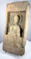 Early Chinese Buddhist devotional relief showing a seated Buddha with raised blessing gesture and circular halo