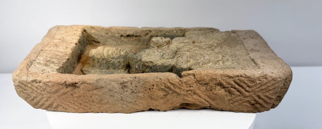 Ancient Northern Wei terracotta brick showing thickness, rough architectural edges and recessed Buddha carving