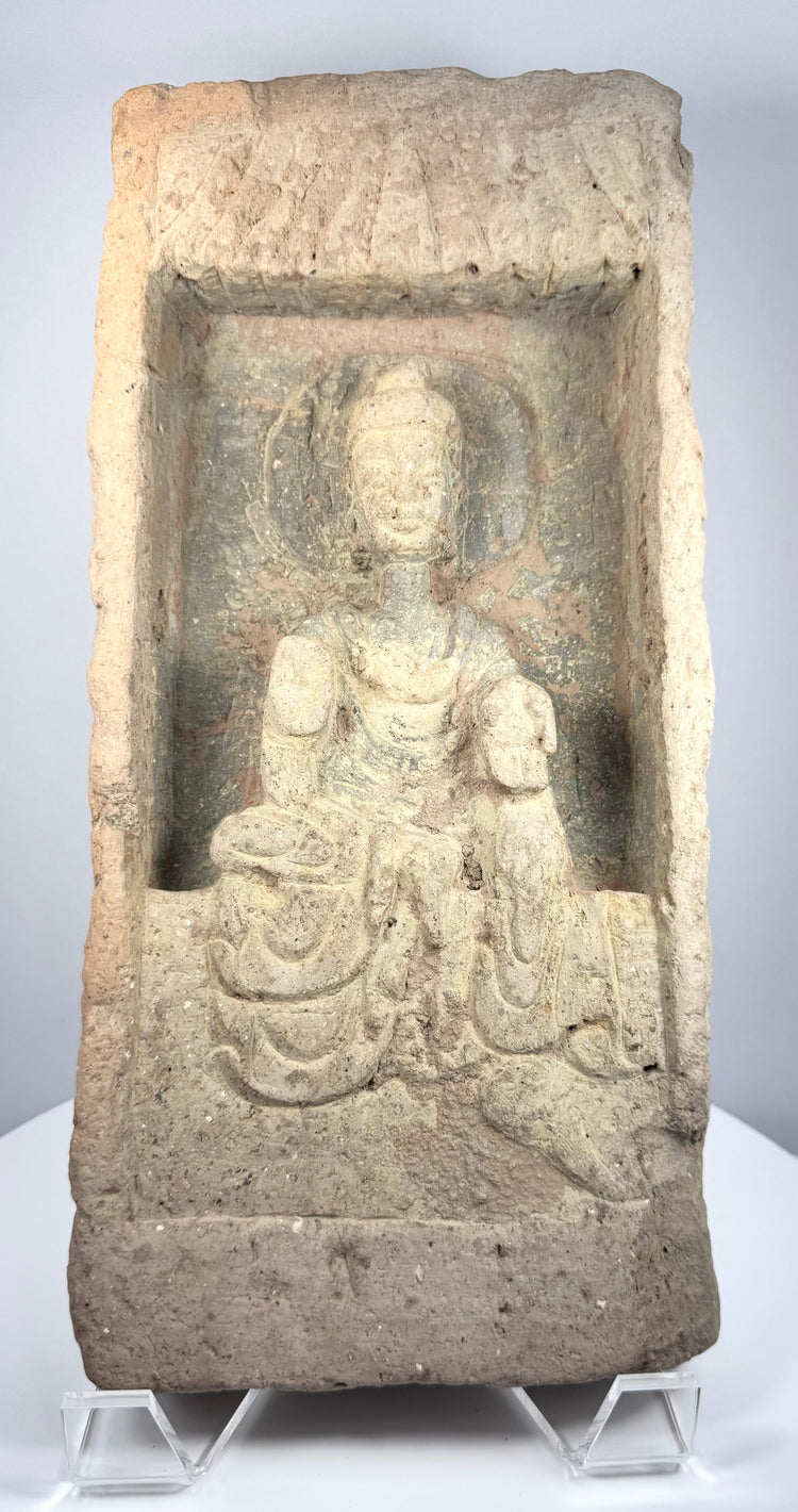 Ancient Chinese Buddhist brick depicting a seated haloed Buddha within a deeply recessed shrine niche