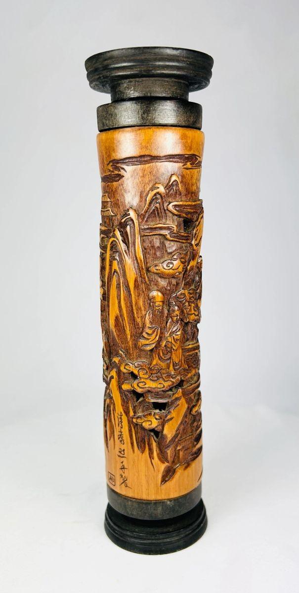 Late 19th-century Chinese boxwood incense holder, intricately hand-carved with detailed landscape and figure scenes, cylindrical form with dark-stained end caps; showcases fine Qing-era craftsmanship in wood carving for ritual and domestic use.