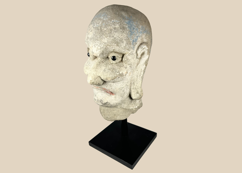Qing Dynasty carved Chinese stone head of a Luohan with traces of original polychrome pigment.