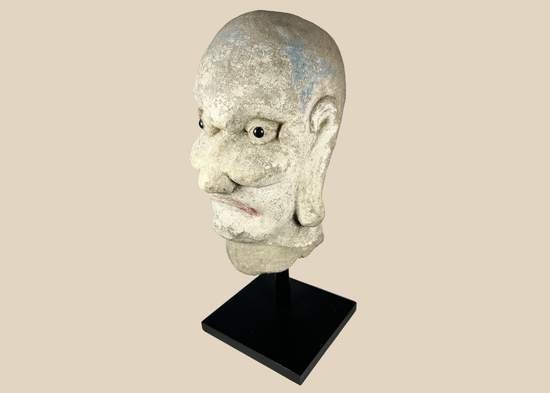 Qing Dynasty carved Chinese stone head of a Luohan with traces of original polychrome pigment.