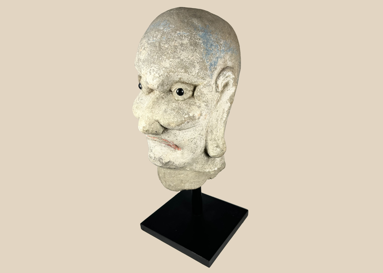 Qing Dynasty carved Chinese stone head of a Luohan with traces of original polychrome pigment.