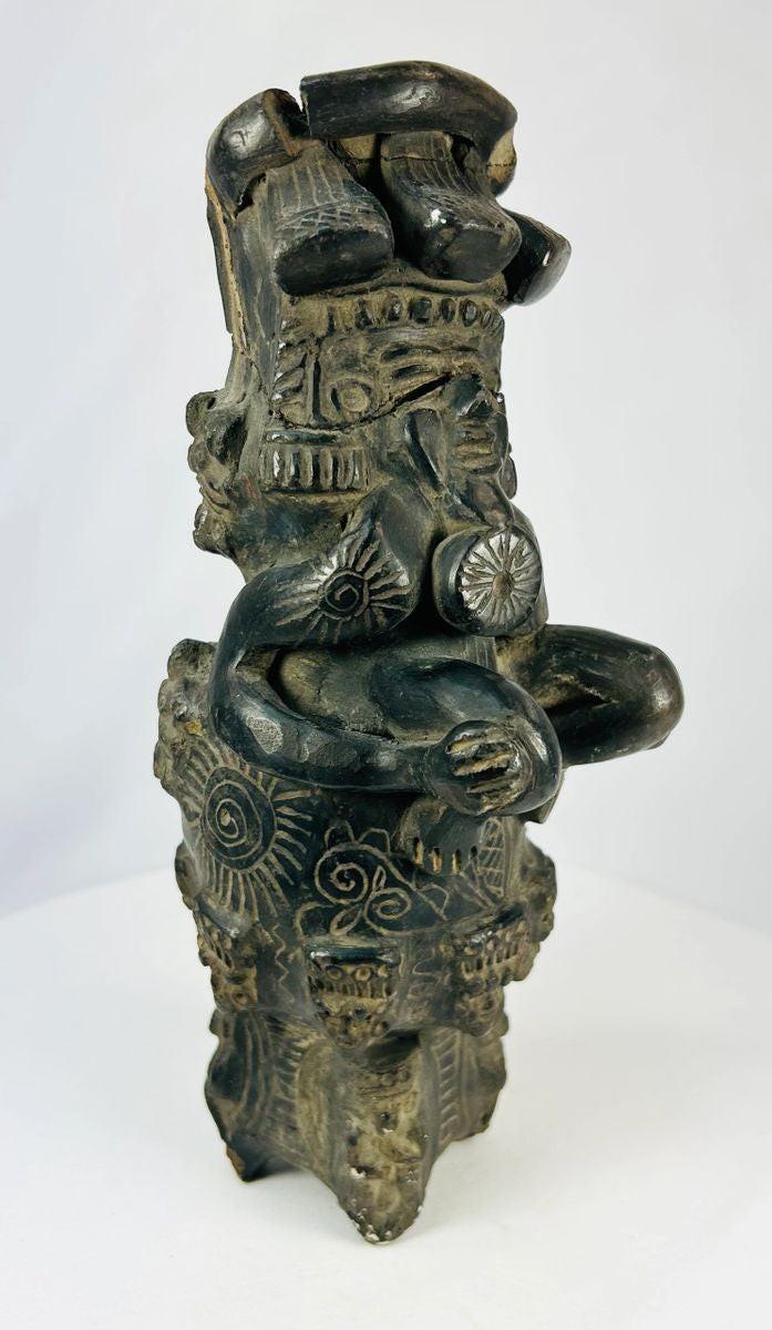 Vintage Chupícuaro-style ceramic figure from West Mexico, depicting a stylized seated form with intricate geometric motifs and applied details. Handcrafted revival piece inspired by pre-Columbian tradition, with dark burnished finish and patina.