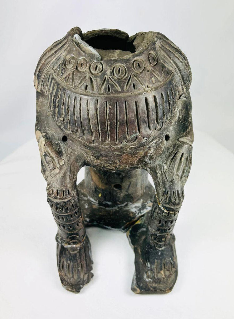 Terracotta figure in Chupicuaro style from West Mexico, mid-20th century, with hollow body, geometric incised motifs, pierced vent holes, and surface patina. A reproduction inspired by ancient Mesoamerican funerary and ceremonial sculpture.