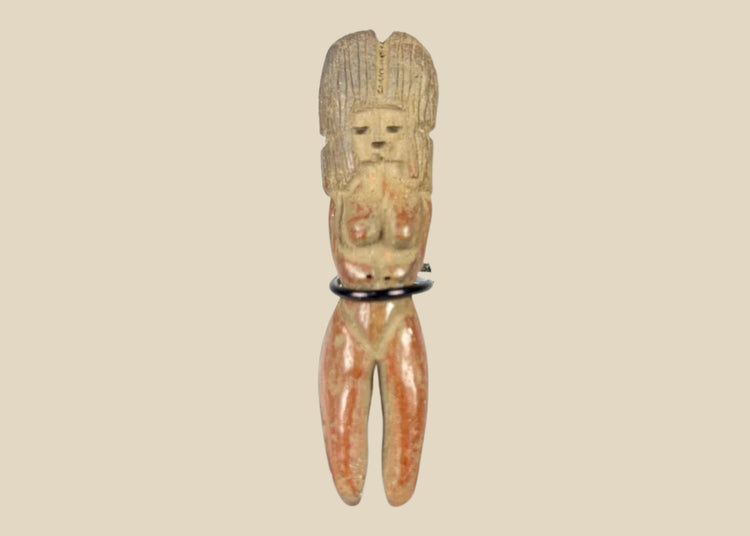 Molded terracotta figurine of seated female from Classic Veracruz culture, with vertical ridged headdress, bent legs, hands raised to face, incised facial features, and traces of red slip; mounted on black display stand; circa 600–900 CE, Gulf Coast of Mexico.