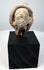 Ancient Greek or Roman terracotta head fragment from the Mediterranean, featuring a serene classical face and weathered surface.
