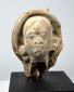 Classical antiquity terracotta head with softly modeled facial features and traces of an ancient headdress or head covering.