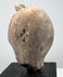 Classical Greek or Roman terracotta sculpture fragment with preserved face, prominent headdress, and natural archaeological patina.