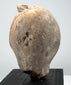 Classical Greek or Roman terracotta sculpture fragment with preserved face, prominent headdress, and natural archaeological patina.