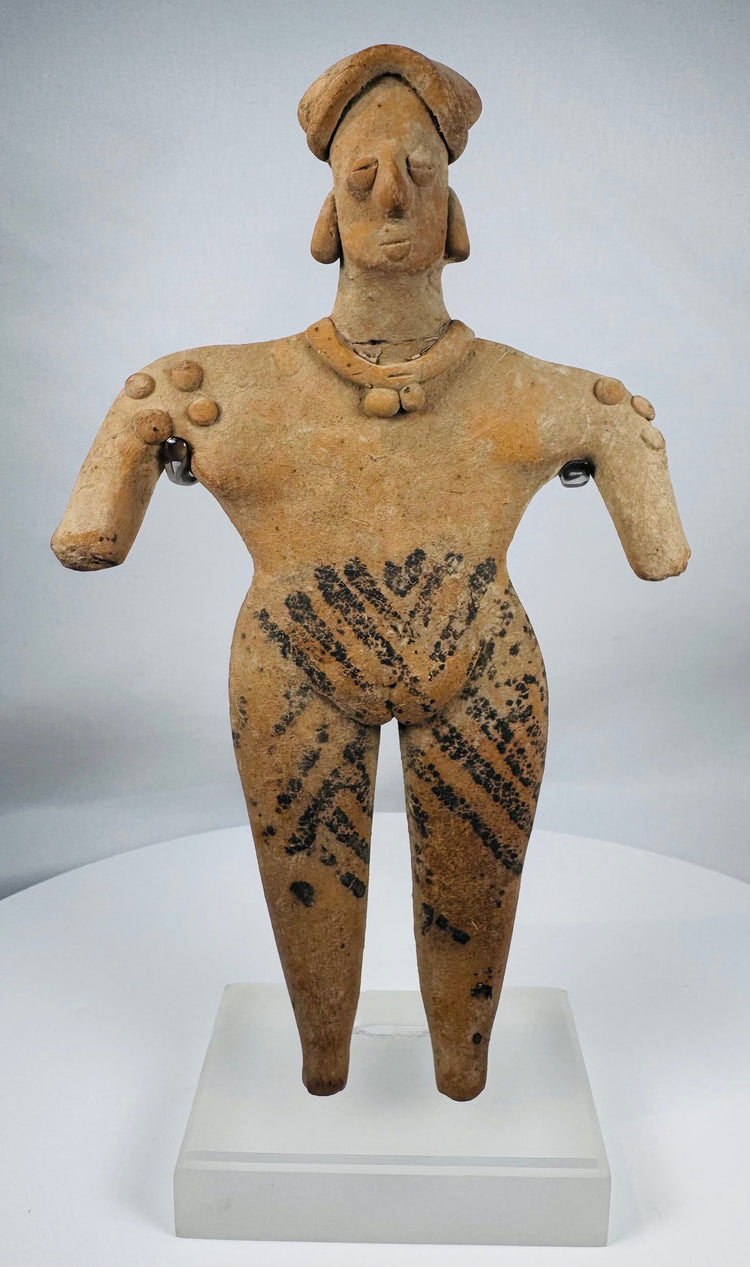 Ancient West Mexican Colima terracotta figure depicting a standing female with stylized facial features and ceremonial ornamentation.