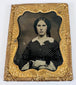 Victorian cased portrait of a woman in a patterned dress with ornate gilt-brass decorative mat