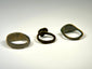 Ancient bronze finger ring collection showing three distinct bezel and band designs