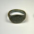 Ancient bronze oval signet ring with engraved bezel and deep olive patina, Roman to Early Medieval period